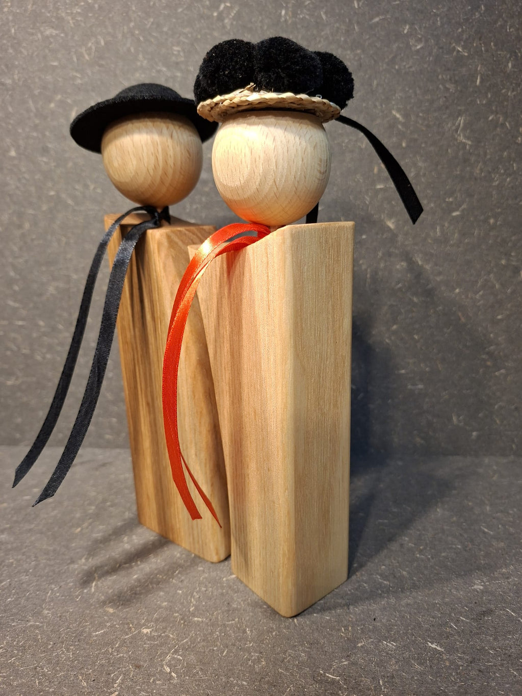 Handgefertigte Schwarzwald Figuren aus Holz als Paar mit schwarzem Bollenhut und Trachtenhut.